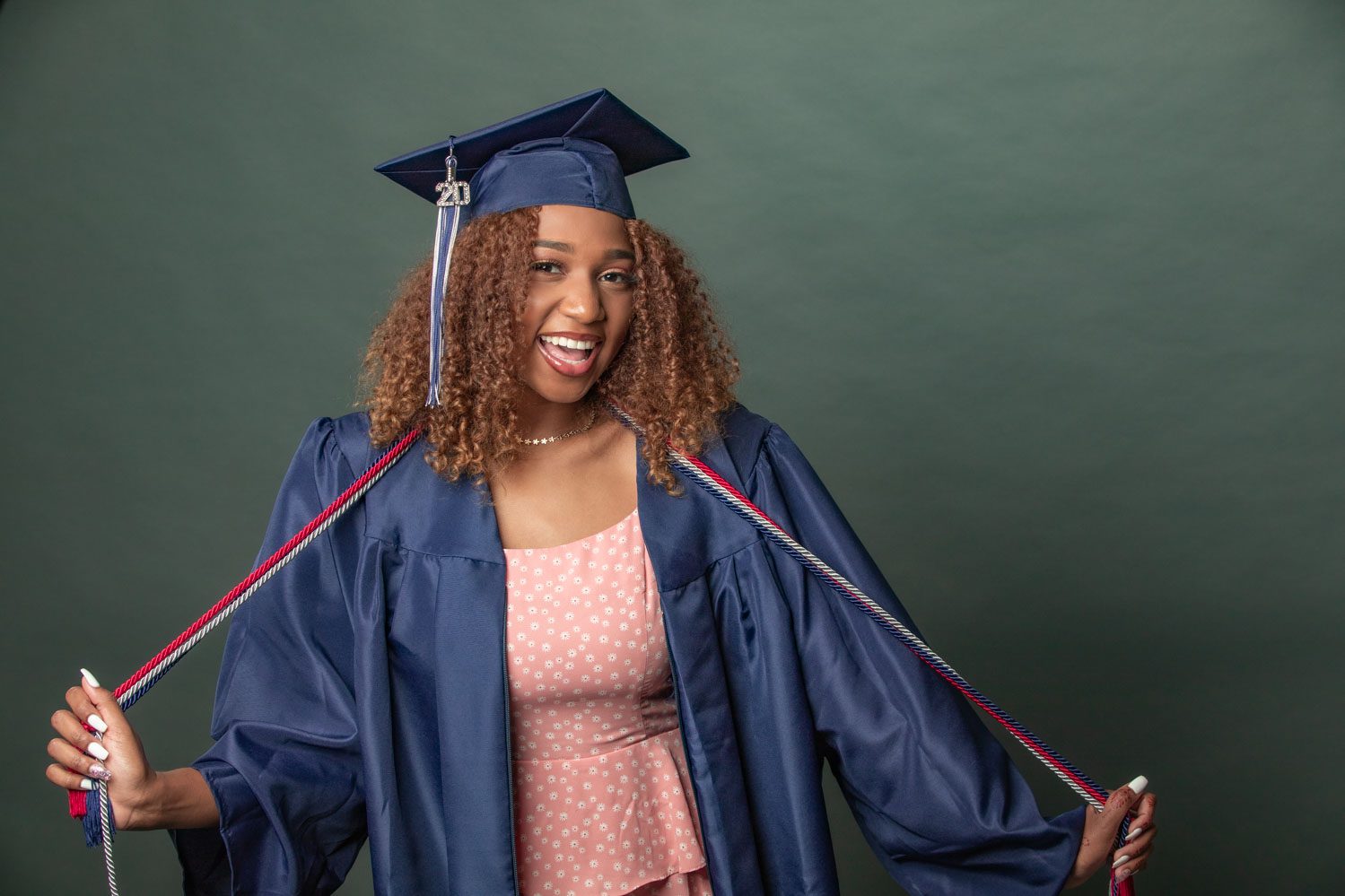 graduate in a pink dress with white flowers