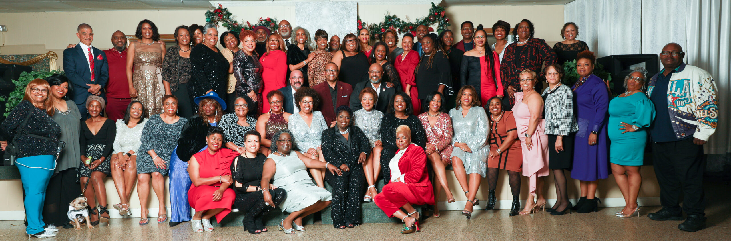 A group of people that are sitting in front of a tree.