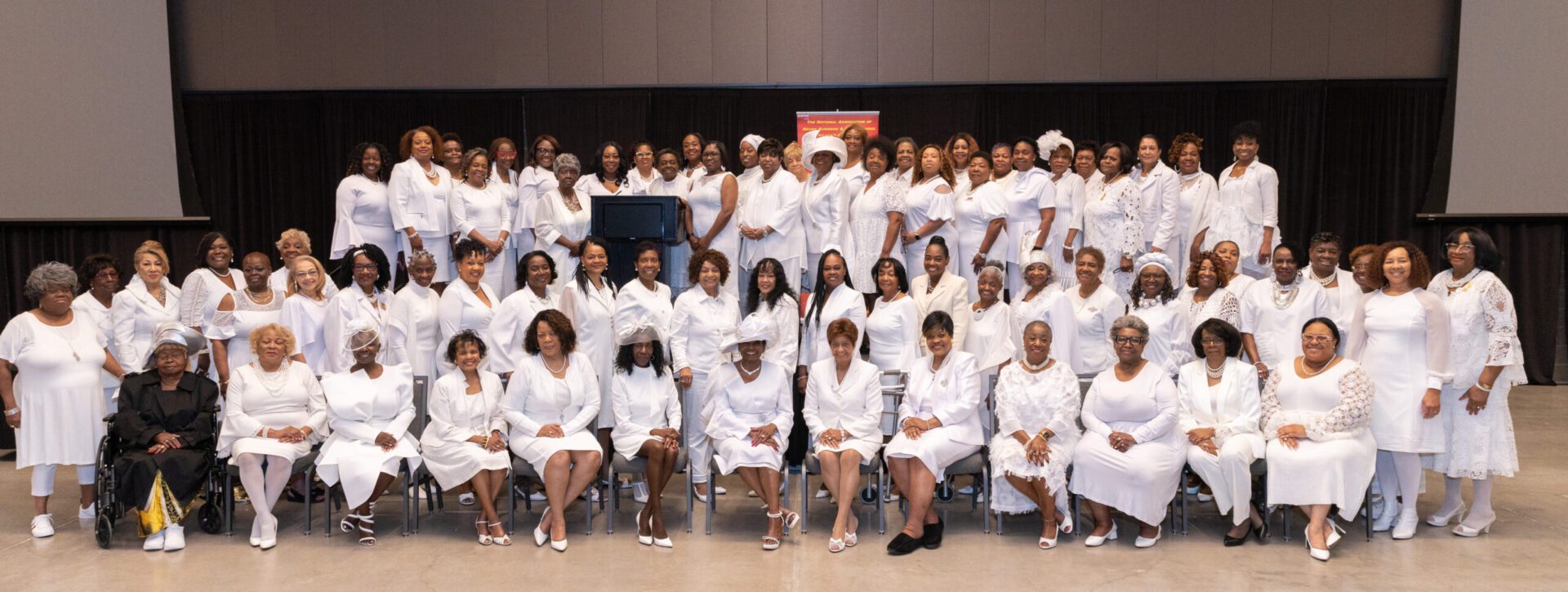 A group of people in white robes and hats.